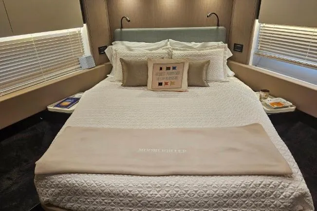  Yacht Photos Pics Luxurious bedroom interior of 2022 Azimut 66 yacht with elegant bedding and modern decor.