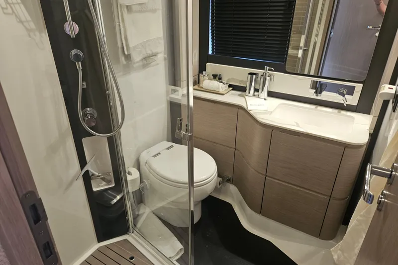  Yacht Photos Pics Luxurious bathroom in 2022 Azimut 66 yacht, featuring modern fixtures and elegant design.