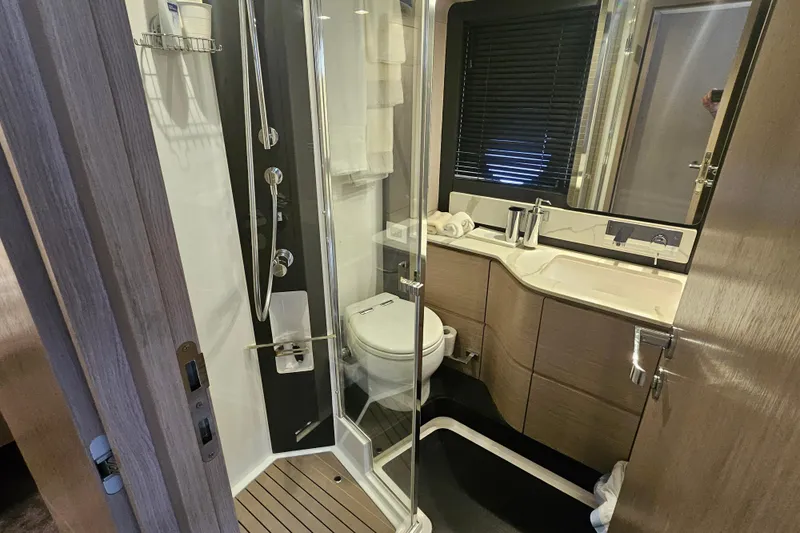  Yacht Photos Pics Luxurious bathroom in 2022 Azimut 66 yacht with modern fixtures and elegant design.