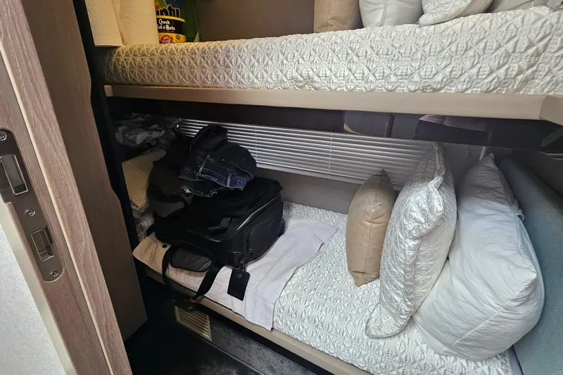  Yacht Photos Pics Bunk beds in 2022 Azimut 66 yacht cabin with luggage and pillows.