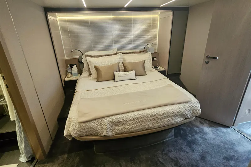  Yacht Photos Pics Luxurious bedroom interior of 2022 Azimut 66 yacht with elegant bedding and modern design.