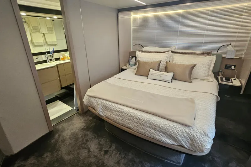  Yacht Photos Pics Luxurious bedroom and bathroom in 2022 Azimut 66 yacht, featuring elegant decor and modern amenities.