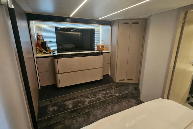  Yacht Photos Pics Luxurious interior of 2022 Azimut 66 yacht with modern TV and elegant cabinetry.