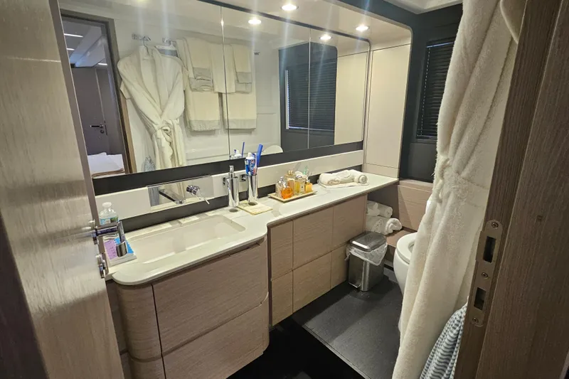  Yacht Photos Pics Luxurious bathroom in 2022 Azimut 66 yacht, featuring modern fixtures and elegant design.