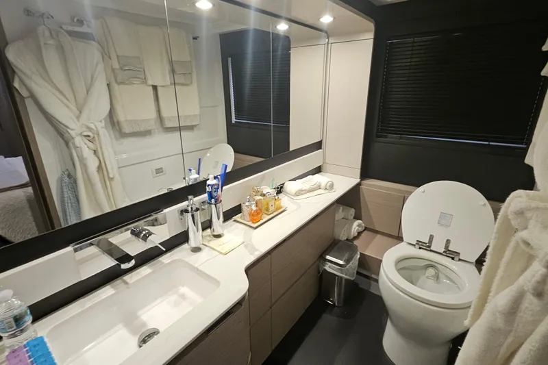  Yacht Photos Pics Luxurious bathroom in 2022 Azimut 66 yacht with modern fixtures and elegant design.