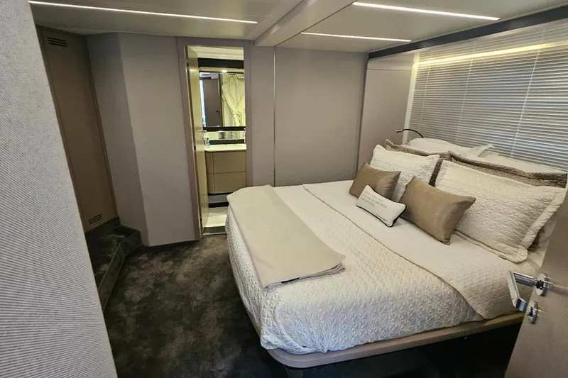  Yacht Photos Pics Luxurious bedroom interior of 2022 Azimut 66 yacht with elegant bedding and modern design.