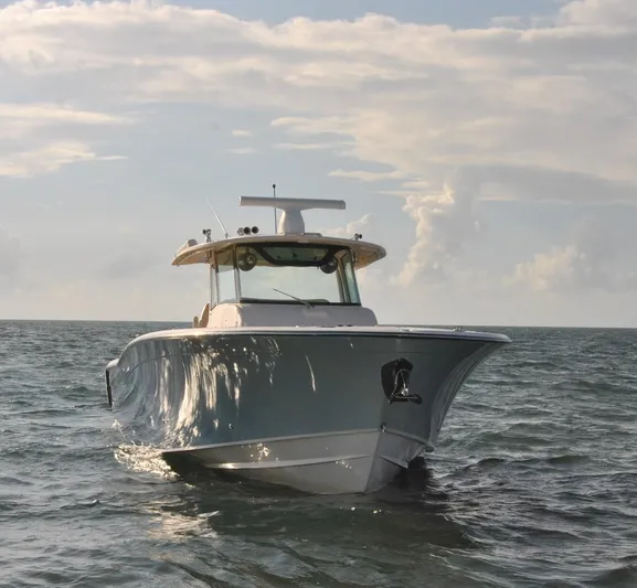  Yacht Photos Pics 2018 Grady-White Canyon 376 boat on open water under cloudy sky.