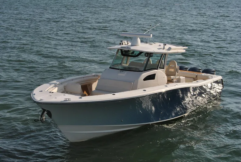  Yacht Photos Pics 2018 Grady-White Canyon 376 boat on open water, showcasing sleek design and spacious deck.