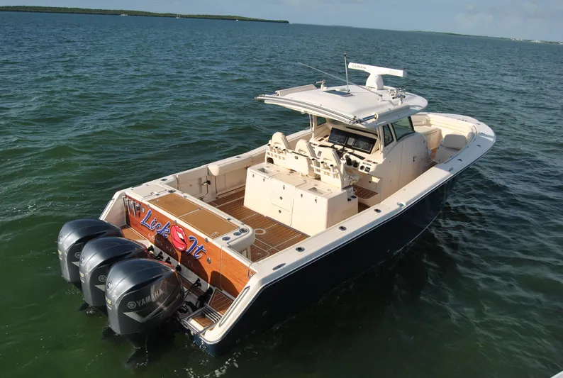  Yacht Photos Pics 2018 Grady-White Canyon 376 boat with triple Yamaha engines on open water.