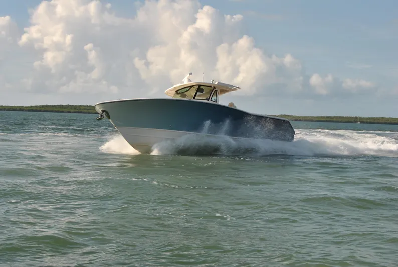  Yacht Photos Pics 2018 Grady-White Canyon 376 boat cruising on open water under a cloudy sky.