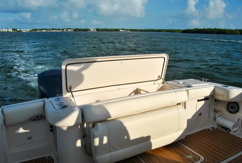  Yacht Photos Pics 2018 Grady-White Canyon 376 boat on water, featuring spacious deck and seating.