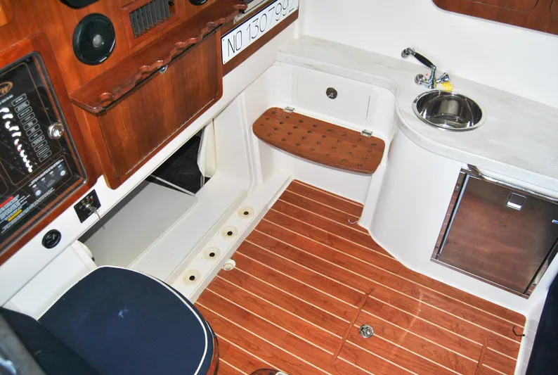  Yacht Photos Pics 2018 Grady-White Canyon 376 interior with wood accents, sink, and seating.
