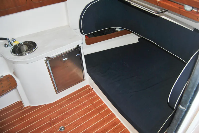  Yacht Photos Pics 2018 Grady-White Canyon 376 cabin interior with sink, mini-fridge, and cushioned seating.