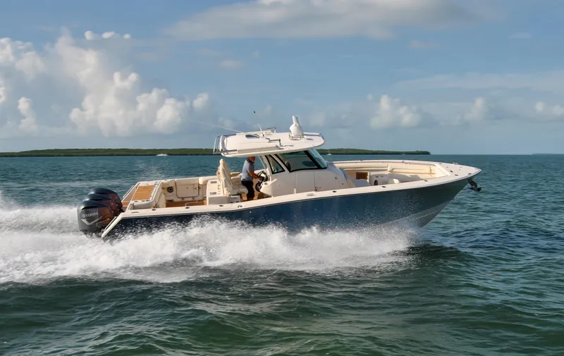  Yacht Photos Pics 2018 Grady-White Canyon 376 boat cruising on open water under a clear sky.