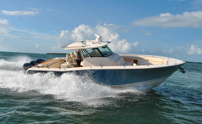  Yacht Photos Pics 2018 Grady-White Canyon 376 boat cruising on open water under a clear blue sky.