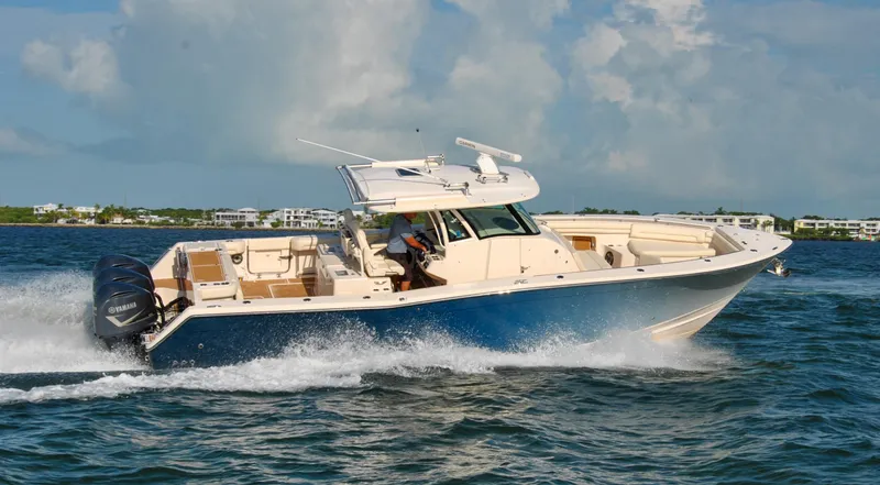  Yacht Photos Pics 2018 Grady-White Canyon 376 boat cruising on open water under a cloudy sky.