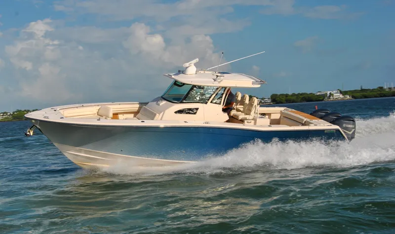  Yacht Photos Pics 2018 Grady-White Canyon 376 boat cruising on open water under a clear sky.