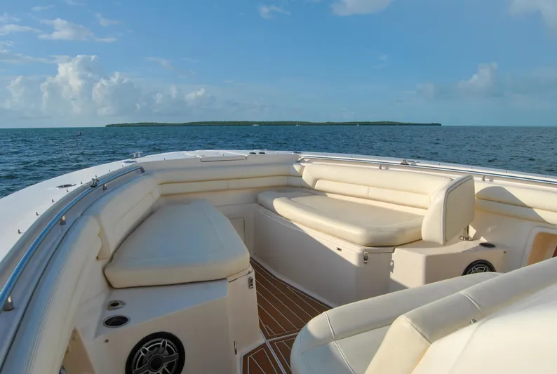  Yacht Photos Pics 2018 Grady-White Canyon 376 boat interior with cushioned seating, ocean view, and clear sky.