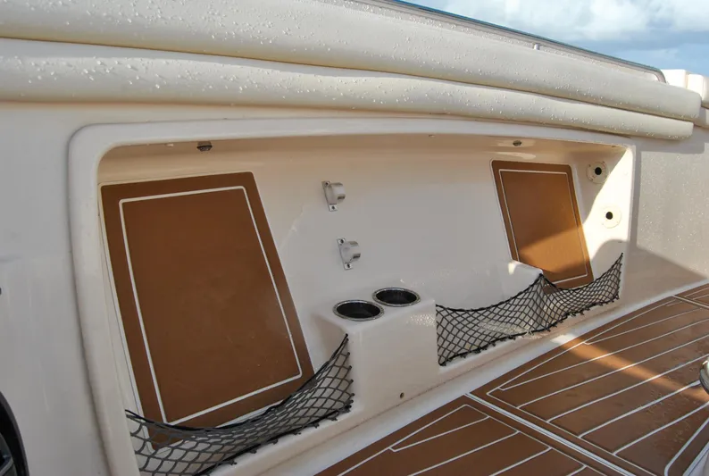  Yacht Photos Pics 2018 Grady-White Canyon 376 boat storage compartment with netting and cup holders.