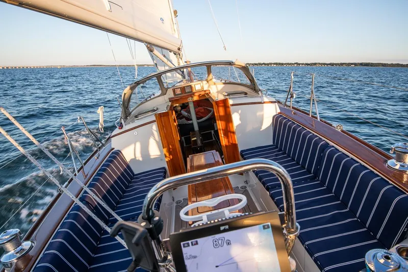Dream Girl Yacht Photos Pics 2007 Morris Yachts M42 sailing on open water, featuring elegant striped seating and wooden accents.