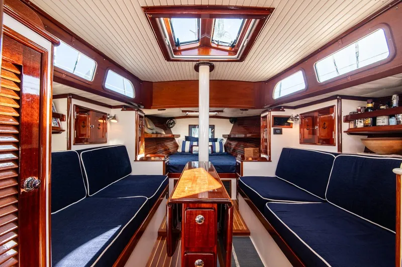 Dream Girl Yacht Photos Pics Luxurious 2007 Morris Yachts M42 interior with elegant wood finish and navy seating.