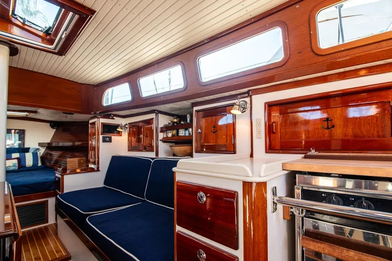 Dream Girl Yacht Photos Pics Luxurious 2007 Morris Yachts M42 interior with polished wood and navy seating.