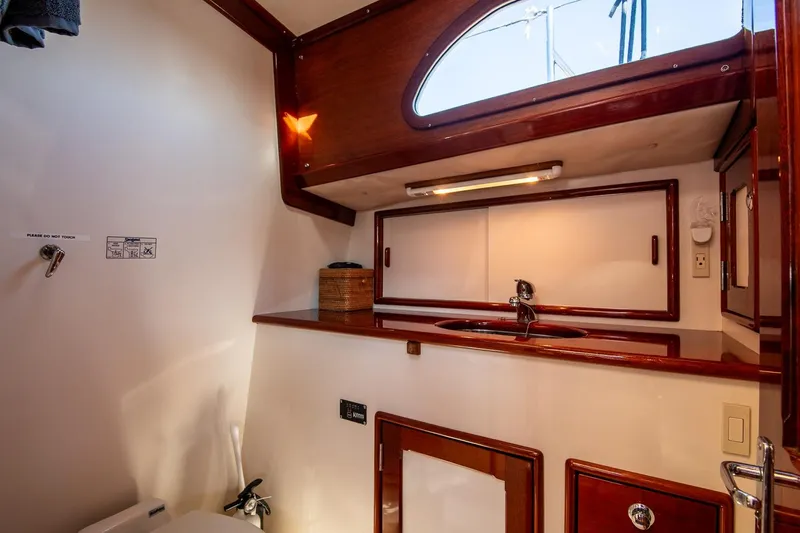 Dream Girl Yacht Photos Pics Luxurious 2007 Morris Yachts M42 bathroom with wooden accents and modern fixtures.