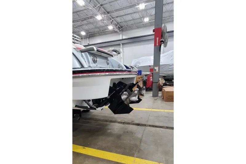  Yacht Photos Pics 2011 Formula 310 FX5 Bowrider in a warehouse, showcasing dual propellers.