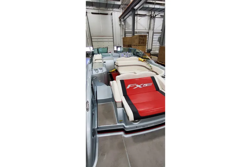  Yacht Photos Pics 2011 Formula 310 FX5 Bowrider boat interior with red and white seating in a warehouse.