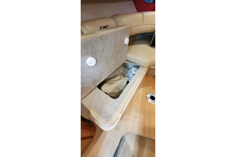 Yacht Photos Pics 2011 Formula 310 FX5 Bowrider interior storage compartment with beige seating and wooden flooring.