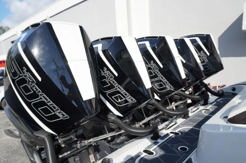  Yacht Photos Pics Four powerful outboard engines on a 2021 MTI V42 boat, showcasing sleek design and performance.