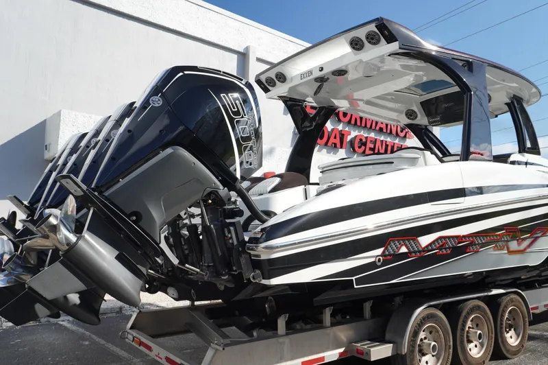  Yacht Photos Pics 2021 MTI V42 boat on trailer with powerful outboard engines at a performance boat center.