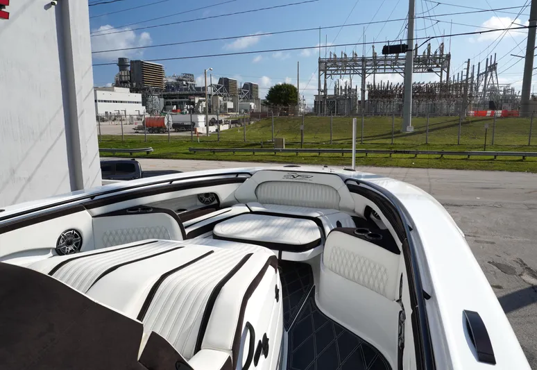  Yacht Photos Pics Luxury MTI V42 boat interior with white seating, industrial background, clear sky, 2021 model.