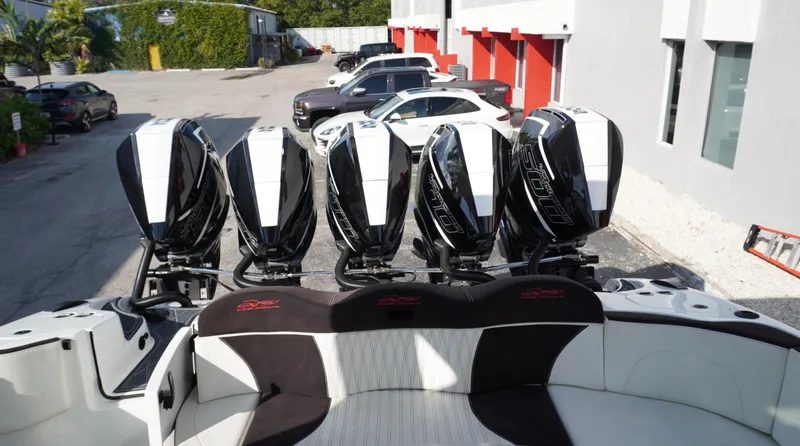  Yacht Photos Pics Five powerful outboard engines on a 2021 MTI V42 boat, parked near a building.