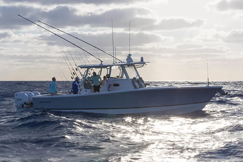  Yacht Photos Pics 2024 Regulator 37 boat on ocean, people fishing under cloudy sky.