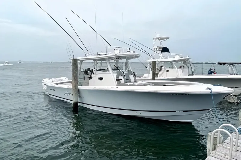  Yacht Photos Pics 2024 Regulator 37 boat docked, featuring sleek design and fishing equipment.