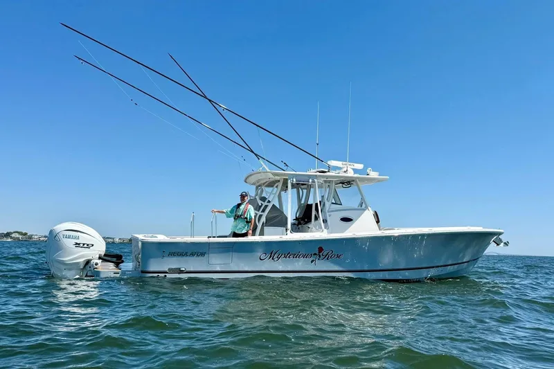  Yacht Photos Pics 2024 Regulator 37 boat on water, featuring Yamaha engine and fishing rods.