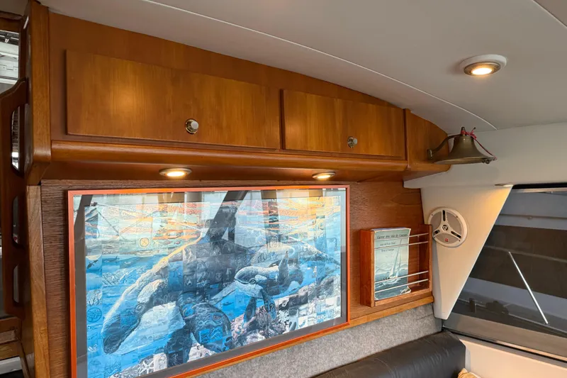 Lady Jake Yacht Photos Pics Interior of 1985 Bayliner 4550 Motoryacht with artwork and wooden cabinetry.