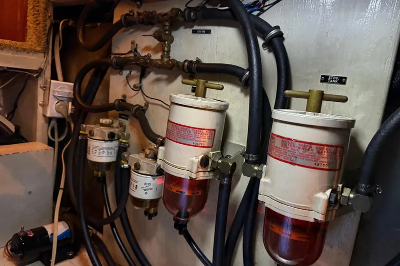 Lady Jake Yacht Photos Pics Engine room of 1985 Bayliner 4550 Motoryacht with fuel filters and hoses.