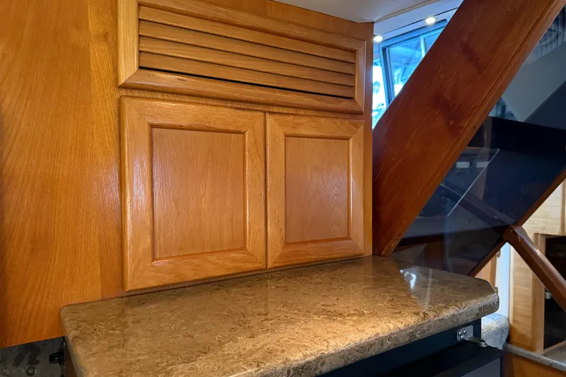 Lady Jake Yacht Photos Pics Interior of 1985 Bayliner 4550 Motoryacht with wooden cabinetry and marble countertop.