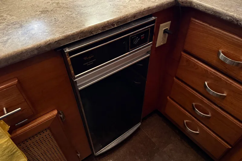 Lady Jake Yacht Photos Pics 1985 Bayliner 4550 Motoryacht kitchen with Whirlpool trash compactor and wooden cabinetry.