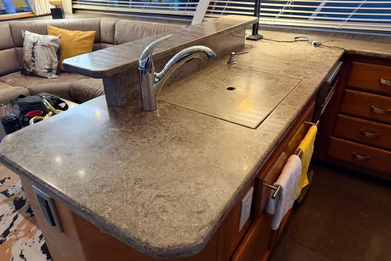 Lady Jake Yacht Photos Pics Luxurious kitchen area in a 1985 Bayliner 4550 Motoryacht with modern countertop and faucet.