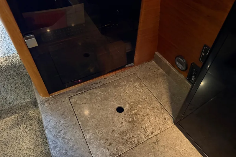 Lady Jake Yacht Photos Pics Interior of 1985 Bayliner 4550 Motoryacht, featuring a marble floor panel with a circular handle.