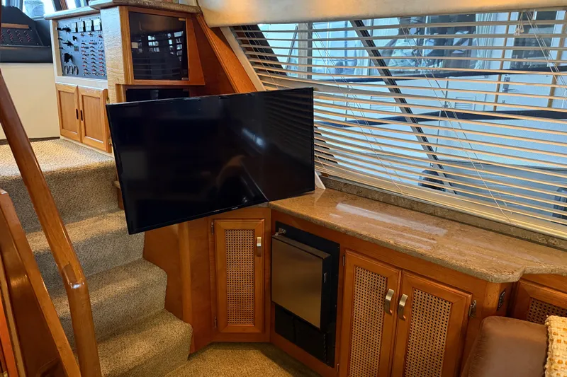 Lady Jake Yacht Photos Pics Interior of 1985 Bayliner 4550 Motoryacht with TV, stairs, and wooden cabinetry.