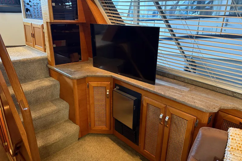 Lady Jake Yacht Photos Pics Interior of 1985 Bayliner 4550 Motoryacht with TV, cabinets, and carpeted stairs.