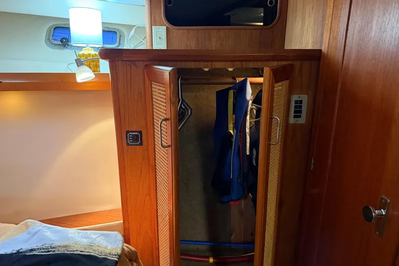 Lady Jake Yacht Photos Pics 1985 Bayliner 4550 Motoryacht interior with wooden closet and hanging life jackets.