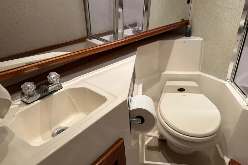 Lady Jake Yacht Photos Pics 1985 Bayliner 4550 Motoryacht bathroom with sink, toilet, and mirror.