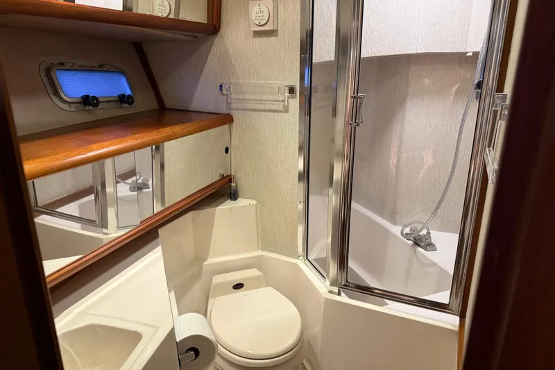 Lady Jake Yacht Photos Pics Bathroom interior of 1985 Bayliner 4550 Motoryacht with shower and wooden accents.