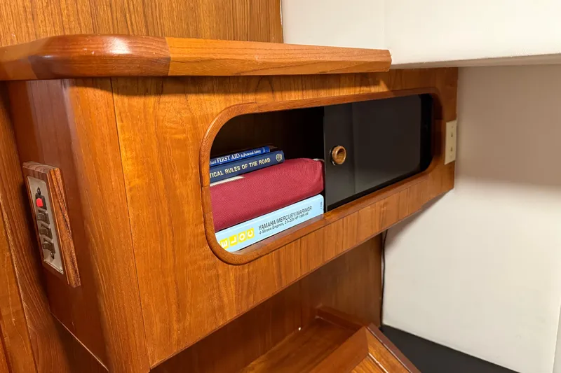 Lady Jake Yacht Photos Pics Wooden interior of 1985 Bayliner 4550 Motoryacht with books and storage compartment.