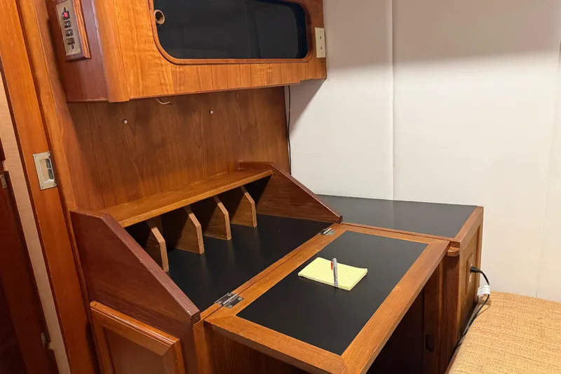Lady Jake Yacht Photos Pics Interior of 1985 Bayliner 4550 Motoryacht with wooden desk and storage compartments.